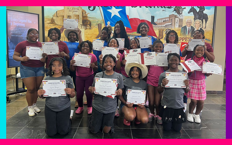 A group photo of teenage girls holding certificates and smiling for the camera.